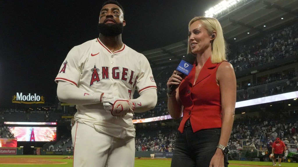 Aug 12, 2025; Anaheim, California, USA; FanDuel Sports Network reporter Erica Weston (right) interviews Los Angeles Angels right fielder Jo Adell (7) after the game against the Los Angeles Dodgers at Angel Stadium.