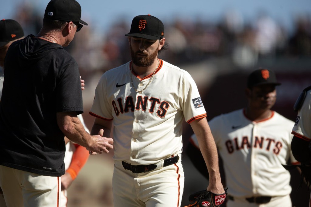 Sep 27, 2025; San Francisco, California, USA; San Francisco Giants pitcher Ryan Walker (74) hands the ball to manager Bob Melvin as he is relieved during the ninth inning against the Colorado Rockies at Oracle Park. Mandatory Credit: D. Ross Cameron-Imagn Images
