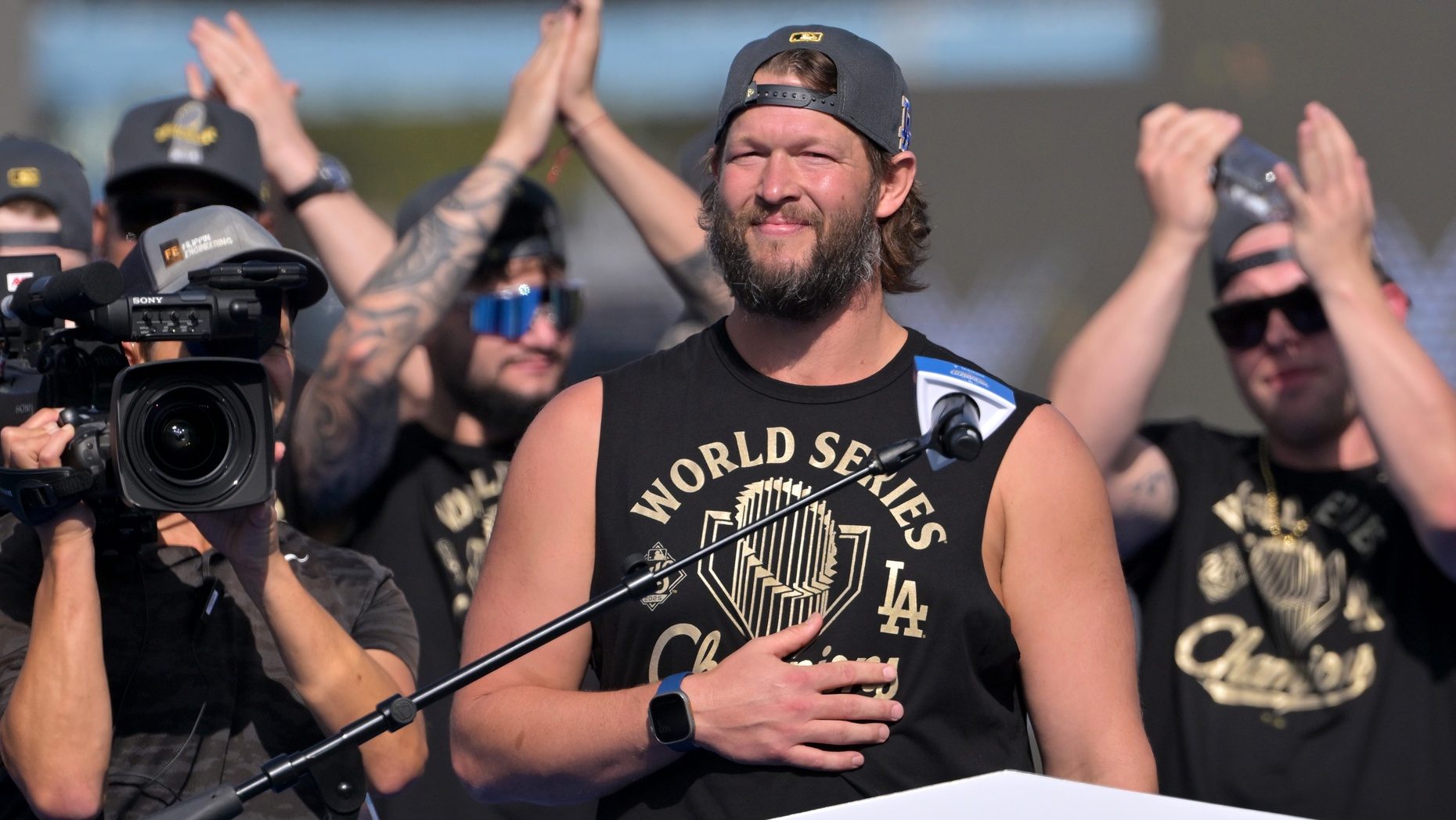 Nov 3, 2025; Los Angeles, CA, USA; Los Angeles Dodgers pitcher Clayton Kershaw (22) speaks to fans during the World Series celebration at Dodger Stadium.