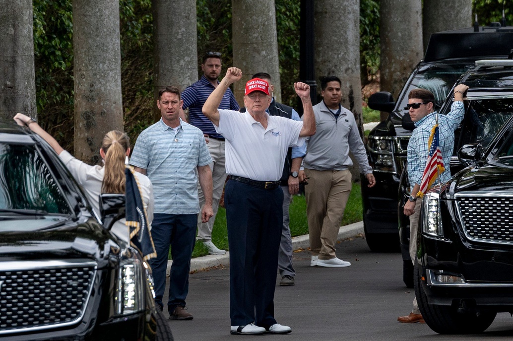 President Donald Trump raises his arms to supporters who gathered across the street fromTrump International Golf Club to celebrate President's Day in West Palm Beach, Florida on February 17, 2025.