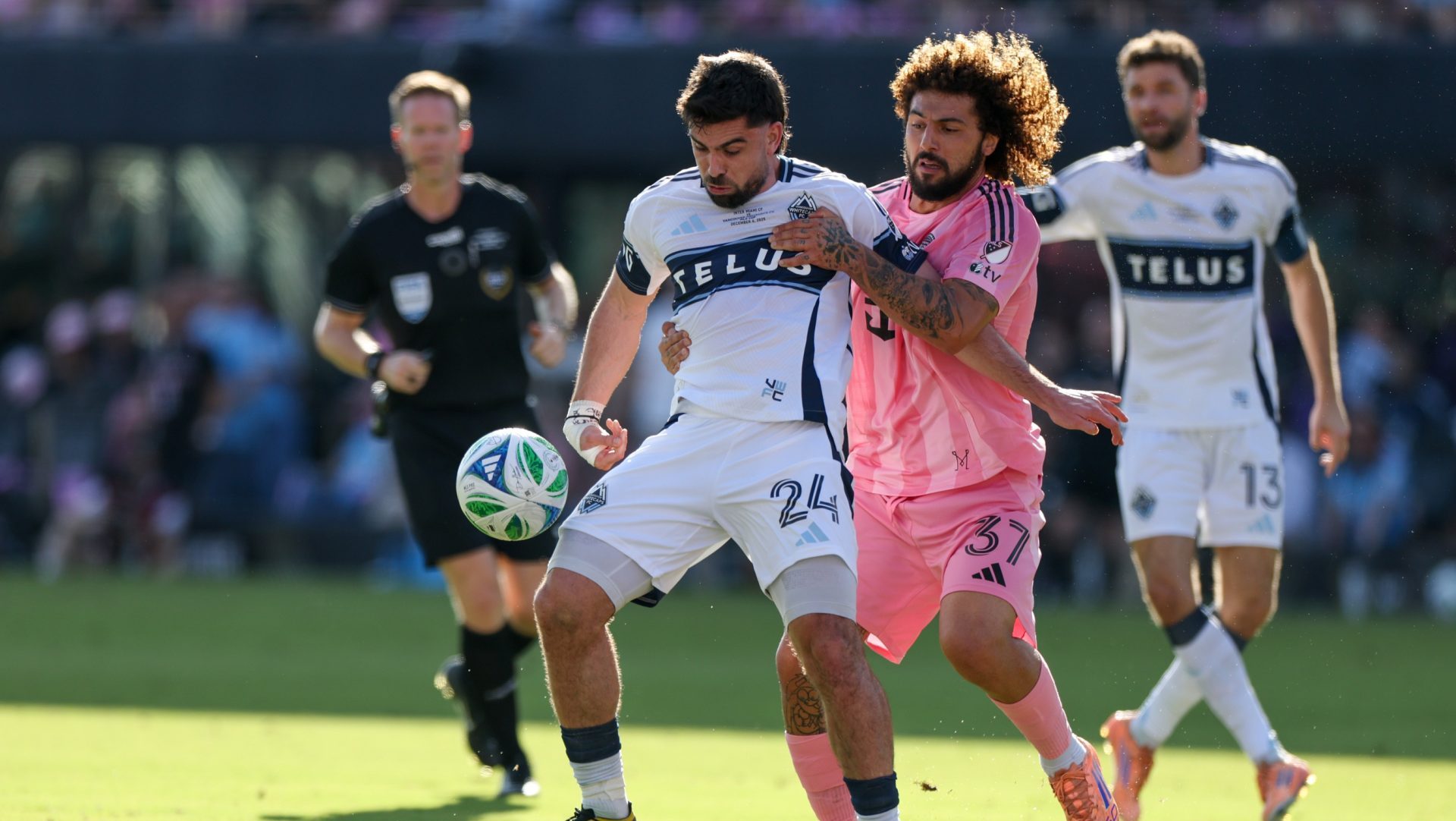 Dec 6, 2025; Fort Lauderdale, Florida, USA; Vancouver Whitecaps FC forward Brian White (24) controls the ball defended by Inter Miami defender Maximiliano Falcon (37) in the first half during the 2025 MLS Cup at Chase Stadium.