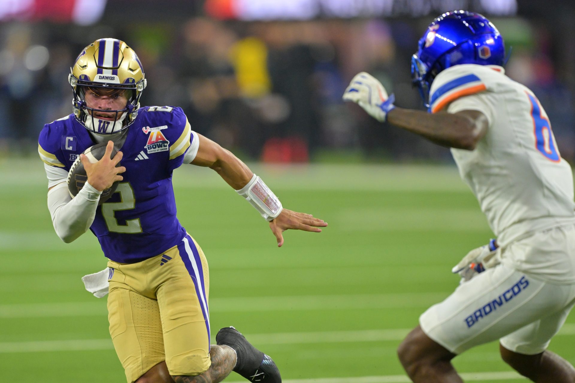 Dec 13, 2025; Inglewood, CA, USA; Washington Huskies quarterback Demond Williams Jr. (2) is forced out of bounds by Boise State Broncos defensive back Jeremiah Earby (6) after a catching a pass in the second half of the LA Bowl at SoFi Stadium.