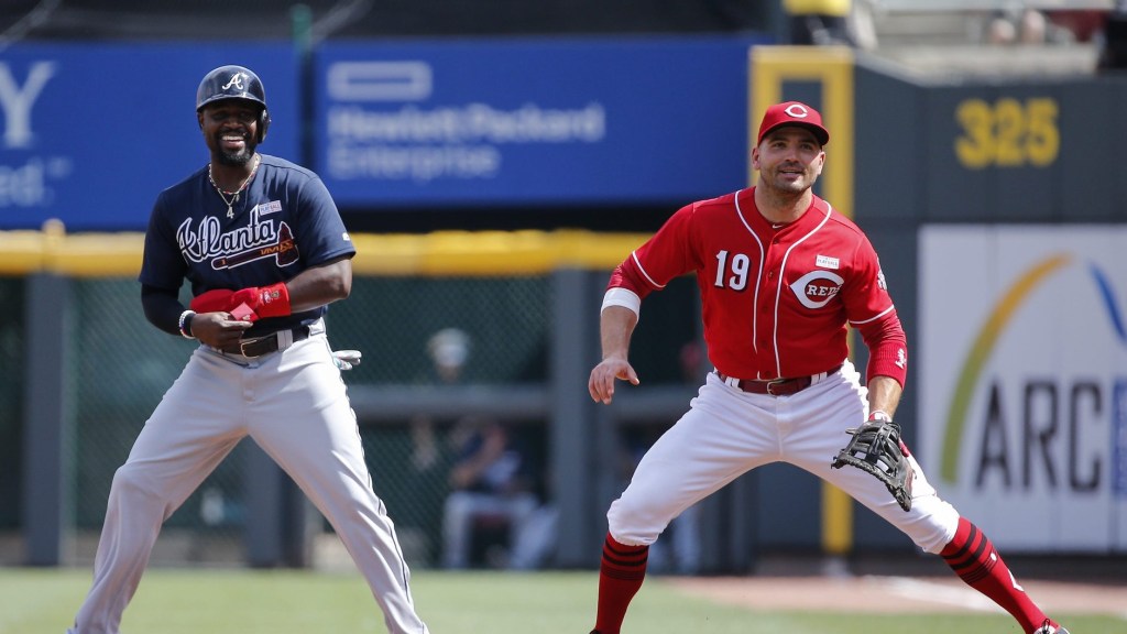 Atlanta Braves second baseman Brandon Phillips, left, and Cincinnati Reds first baseman Joey Votto, share a laugh in the first inning on June 3, 2017, at Great American Ball Park.