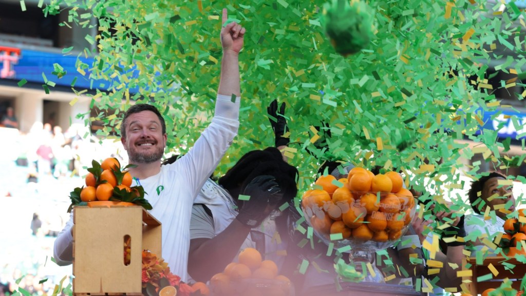 Jan 1, 2026; Miami Gardens, FL, USA; Oregon Ducks head coach Dan Lanning and players on the podium to receive the champions trophy following the 2025 Orange Bowl and quarterfinal game of the College Football Playoff against the Texas Tech Red Raiders at Hard Rock Stadium.