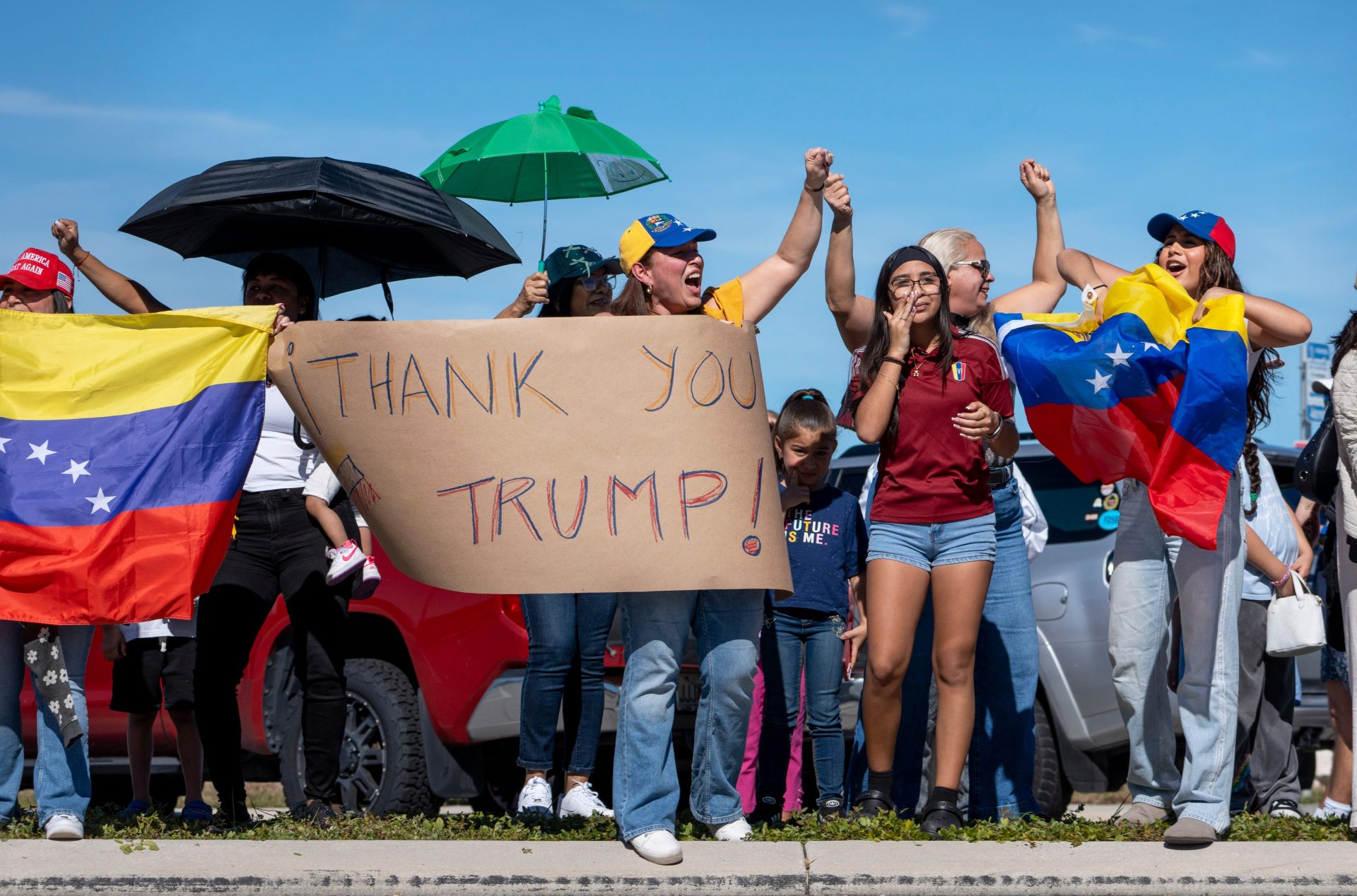 People celebrate near Mar-a-Lago in Palm Beach, Florida, while President Trump has a press conference about US forces capturing Venezuela's leader Nicolas Maduro after bombing the capital Caracas on January 3, 2026.