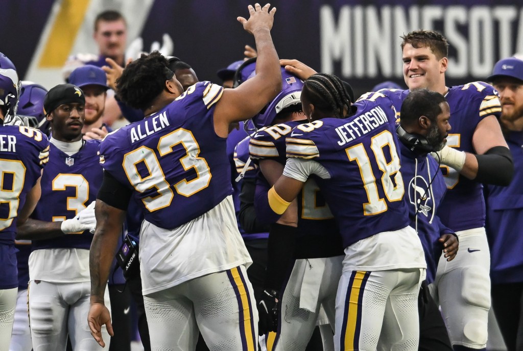 Jan 4, 2026; Minneapolis, Minnesota, USA; Minnesota Vikings safety Harrison Smith (22) teammates greet him on the sideline against the Green Bay Packers during the fourth quarter at U.S. Bank Stadium.