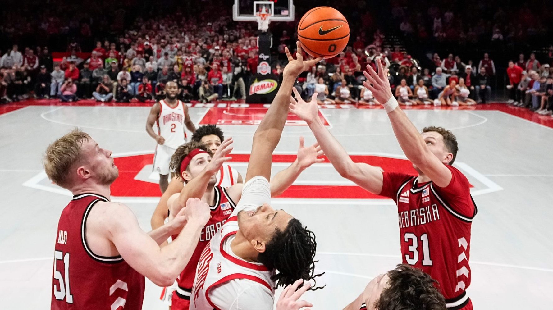 Ohio State Buckeyes forward Devin Royal (21) reaches for a rebound between the Nebraska Cornhuskers team during the second half of the NCAA men's basketball game at the Schottenstein Center in Columbus on Jan. 5, 2026. Ohio State lost 72-69.