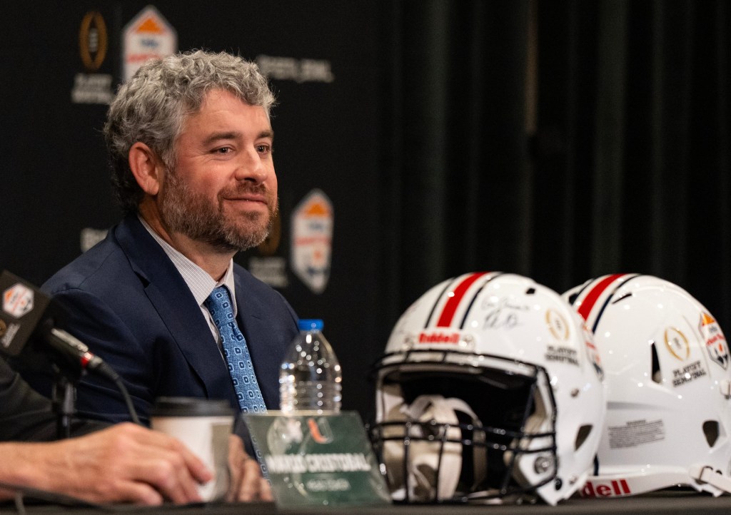 Ole Miss Head Coach Pete Golding smiles while Miami Head Coach Mario Cristobal answers a question during a CFP and Fiesta Bowl press conference at the JW Marriott Scottsdale Camelback Inn Resort & Spa, in Scottsdale, Ariz., on Wednesday, Jan. 7, 2026.