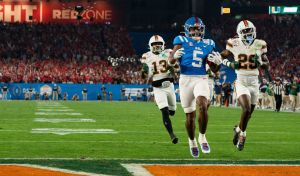 Ole Miss running back Kewan Lacy (5) scores a touchdown during the CFP Fiesta Bowl against Miami at the State Farm Stadium, in Glendale, Ariz., on Thursday, Jan. 8, 2026.