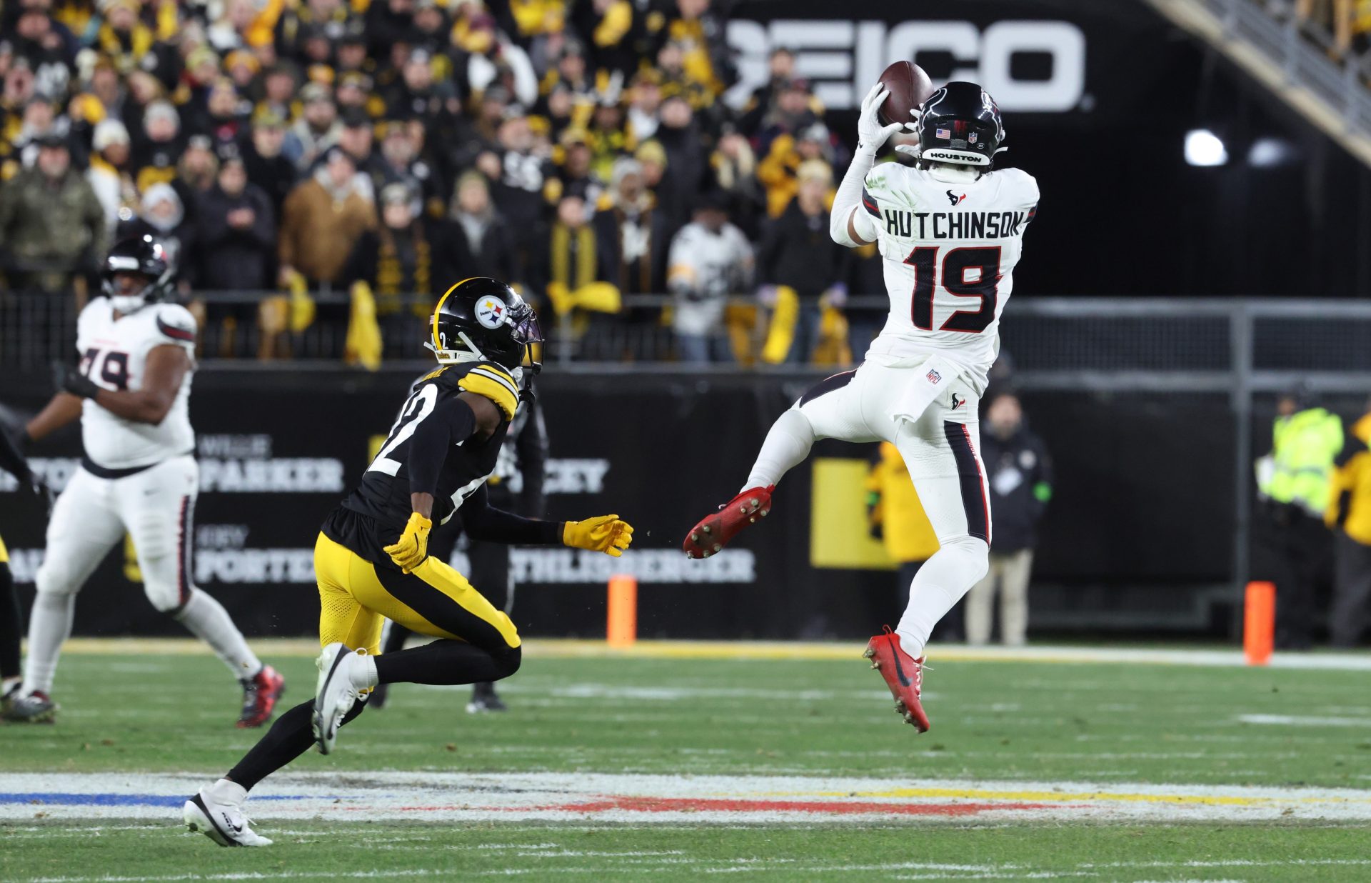 Jan 12, 2026; Pittsburgh, PA, USA; Houston Texans wide receiver Xavier Hutchinson (19) makes a catch against Pittsburgh Steelers cornerback James Pierre (42) during the first half of an AFC Wild Card Round game at Acrisure Stadium.