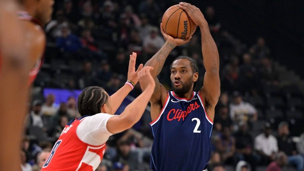 Jan 14, 2026; Inglewood, California, USA; Los Angeles Clippers forward Kawhi Leonard (2) shoots over Washington Wizards forward Kyshawn George (18) in the first half at Intuit Dome.