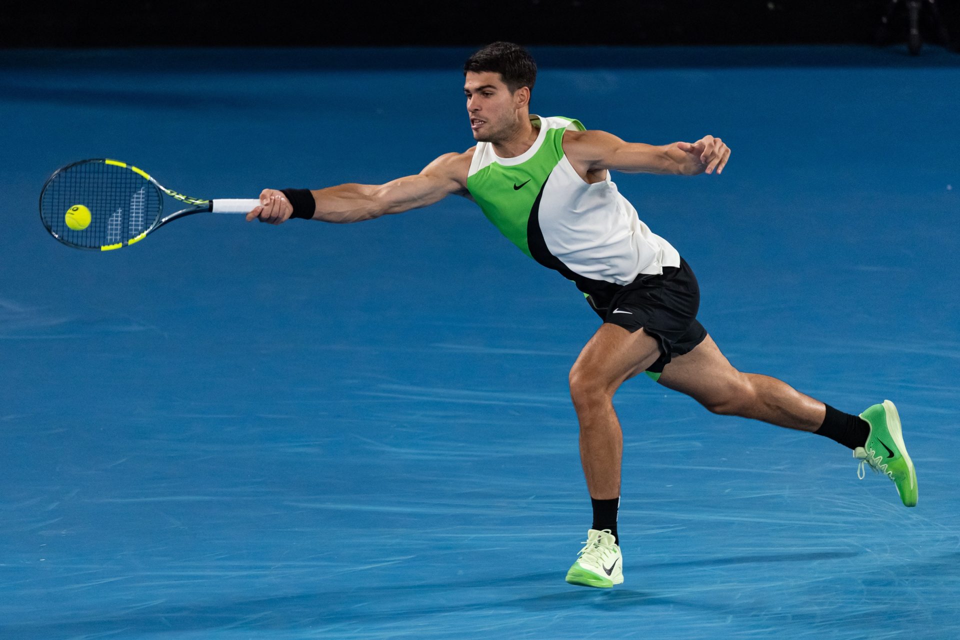 Jan 18, 2026; Melbourne, Victoria, Australia; Carlos Alcaraz of Spain in action against Adam Walton of Australia in the first round of the men’s singles at the Australian Open at Rod Laver Arena in Melbourne Park.