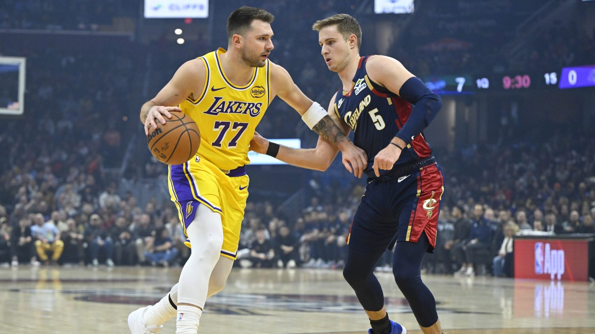 Jan 28, 2026; Cleveland, Ohio, USA; Los Angeles Lakers guard Luka Doncic (77) dribbles beside Cleveland Cavaliers guard Sam Merrill (5) in the first quarter at Rocket Arena.