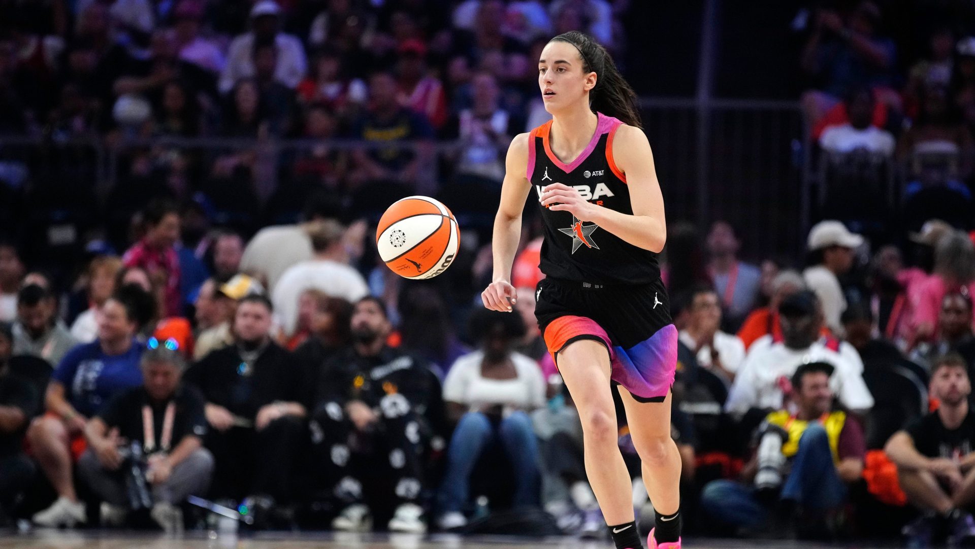 Team WNBA guard Caitlin Clark dribbles up the court against Team USA during the WNBA All-Star Game at Footprint Center in Phoenix on July 20, 2024.