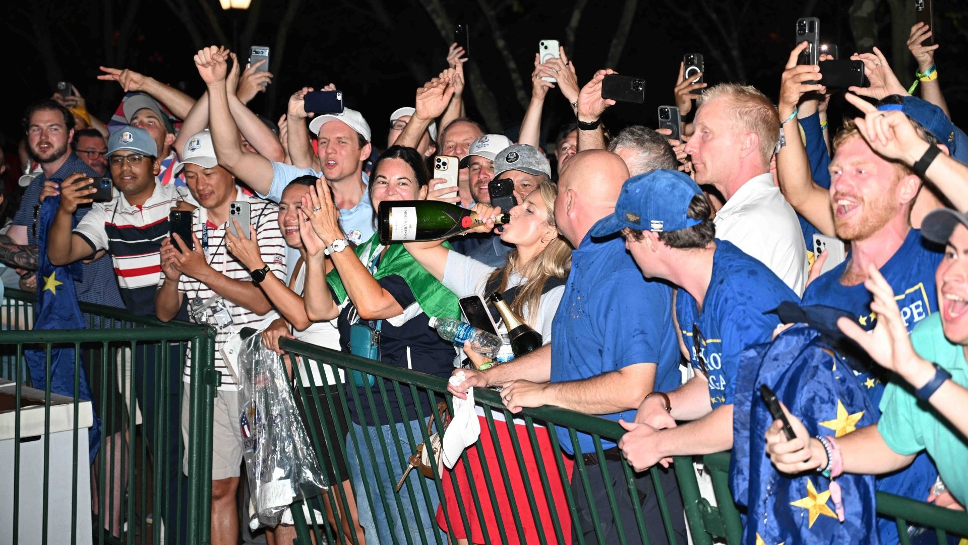 Sep 28, 2025; Bethpage, New York, USA; The crowd drinks champagne in the celebration for Europe winning the Ryder Cup at Bethpage Black. Mandatory Credit: Dennis Schneidler-Imagn Images