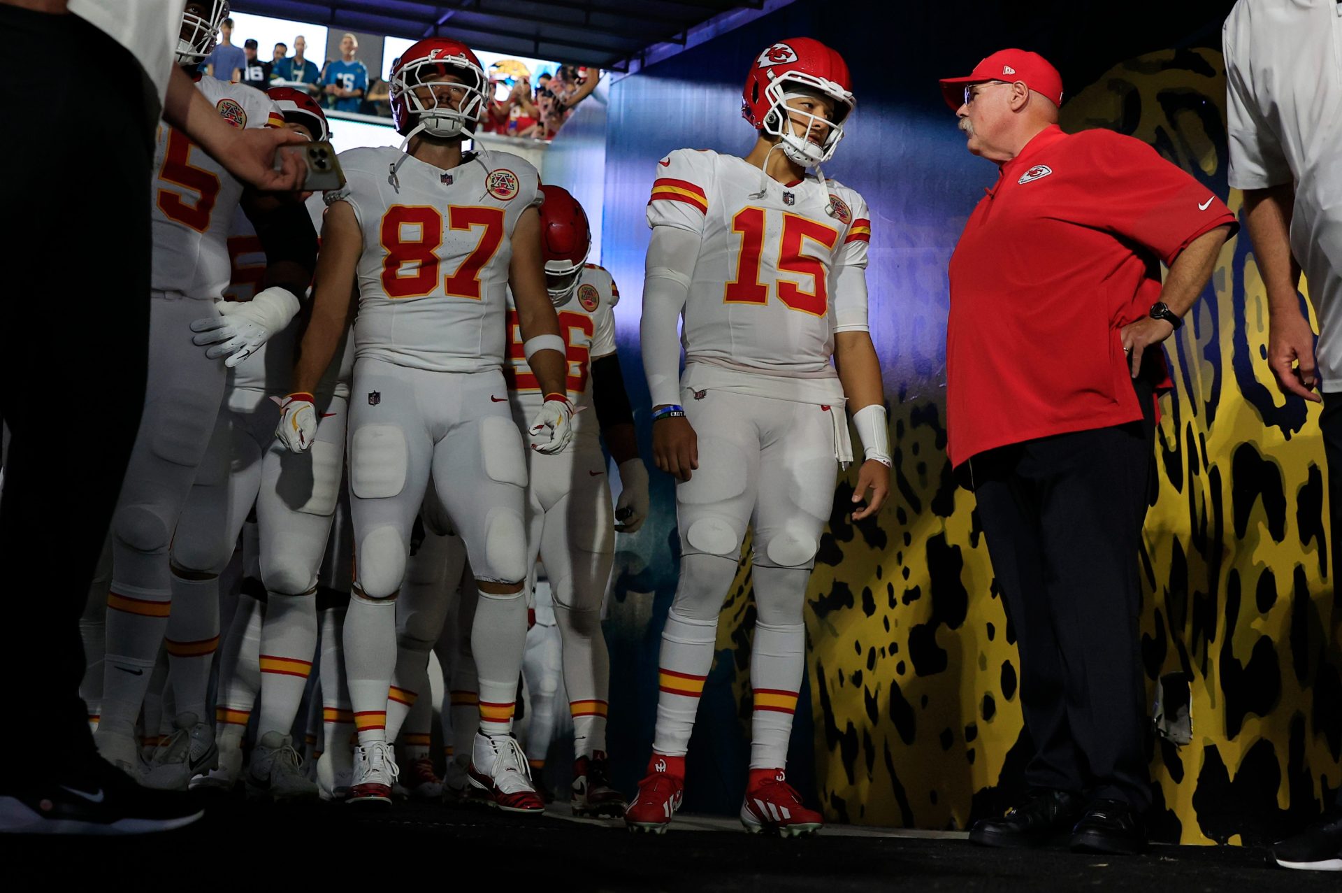 Kansas City Chiefs quarterback Patrick Mahomes (15) talks with head coach Andy Reid with tight end Travis Kelce (87) before an NFL football matchup at EverBank Stadium, Monday, Oct. 6, 2025, in Jacksonville, Fla. The Jacksonville Jaguars edged the Kansas City Chiefs 31-28. [Corey Perrine/Florida Times-Union]