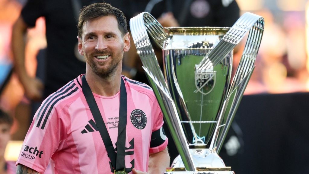 Dec 6, 2025; Fort Lauderdale, Florida, USA; Inter Miami forward Lionel Messi (10) looks on with the Philip F. Anschutz trophy after winning the 2025 MLS Cup against the Vancouver Whitecaps FC at Chase Stadium.