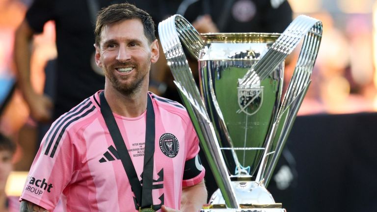 Dec 6, 2025; Fort Lauderdale, Florida, USA; Inter Miami forward Lionel Messi (10) looks on with the Philip F. Anschutz trophy after winning the 2025 MLS Cup against the Vancouver Whitecaps FC at Chase Stadium.