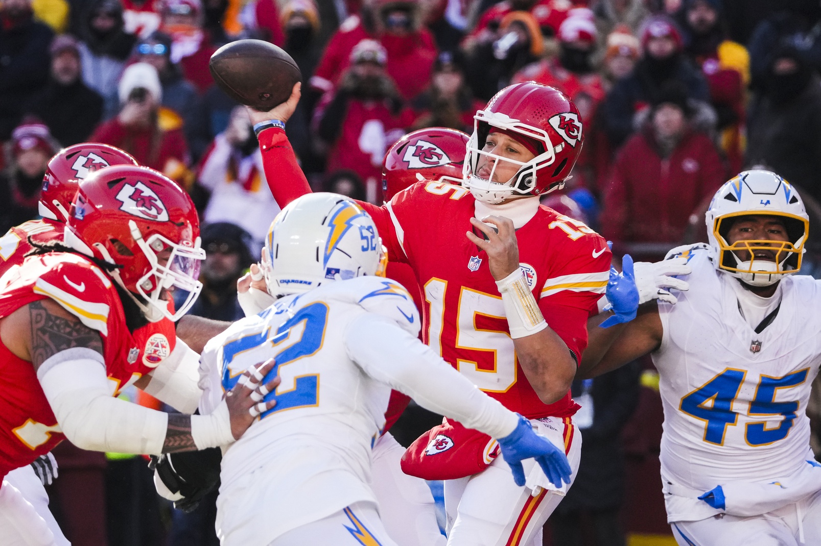 Dec 14, 2025; Kansas City, Missouri, USA; Kansas City Chiefs quarterback Patrick Mahomes (15) passes against the Los Angeles Chargers during the second quarter at GEHA Field at Arrowhead Stadium.