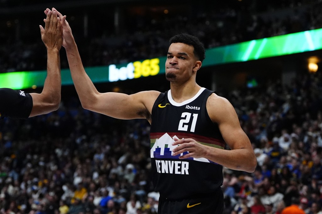 Dec 25, 2025; Denver, Colorado, USA; Denver Nuggets forward Spencer Jones (21) reacts against the Minnesota Timberwolves during the second half at Ball Arena.