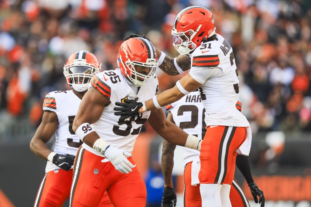 Jan 4, 2026; Cincinnati, Ohio, USA; Cleveland Browns defensive end Myles Garrett (95) celebrates with safety Donovan McMillon (31) following a sack against the Cincinnati Bengals during the fourth quarter at Paycor Stadium. The play set a new NFL single season sack record by Garrett.