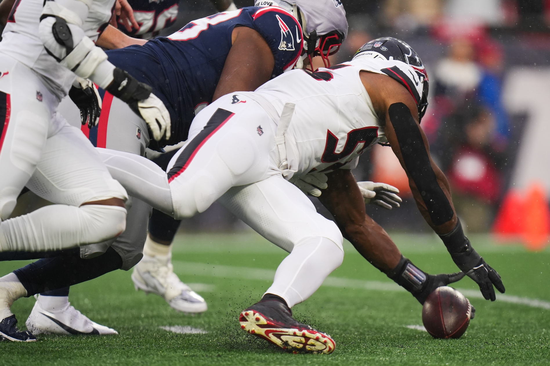 Jan 18, 2026; Foxborough, MA, USA; Houston Texans defensive end Danielle Hunter (55) retrieves a fumble in the first half against the New England Patriots in an AFC Divisional Round game at Gillette Stadium.