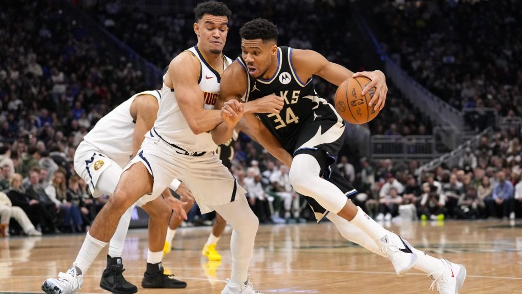 Jan 23, 2026; Milwaukee, Wisconsin, USA; Milwaukee Bucks forward Giannis Antetokounmpo (34) drives for the basket against Denver Nuggets forward Spencer Jones (21) during the second quarter at Fiserv Forum.