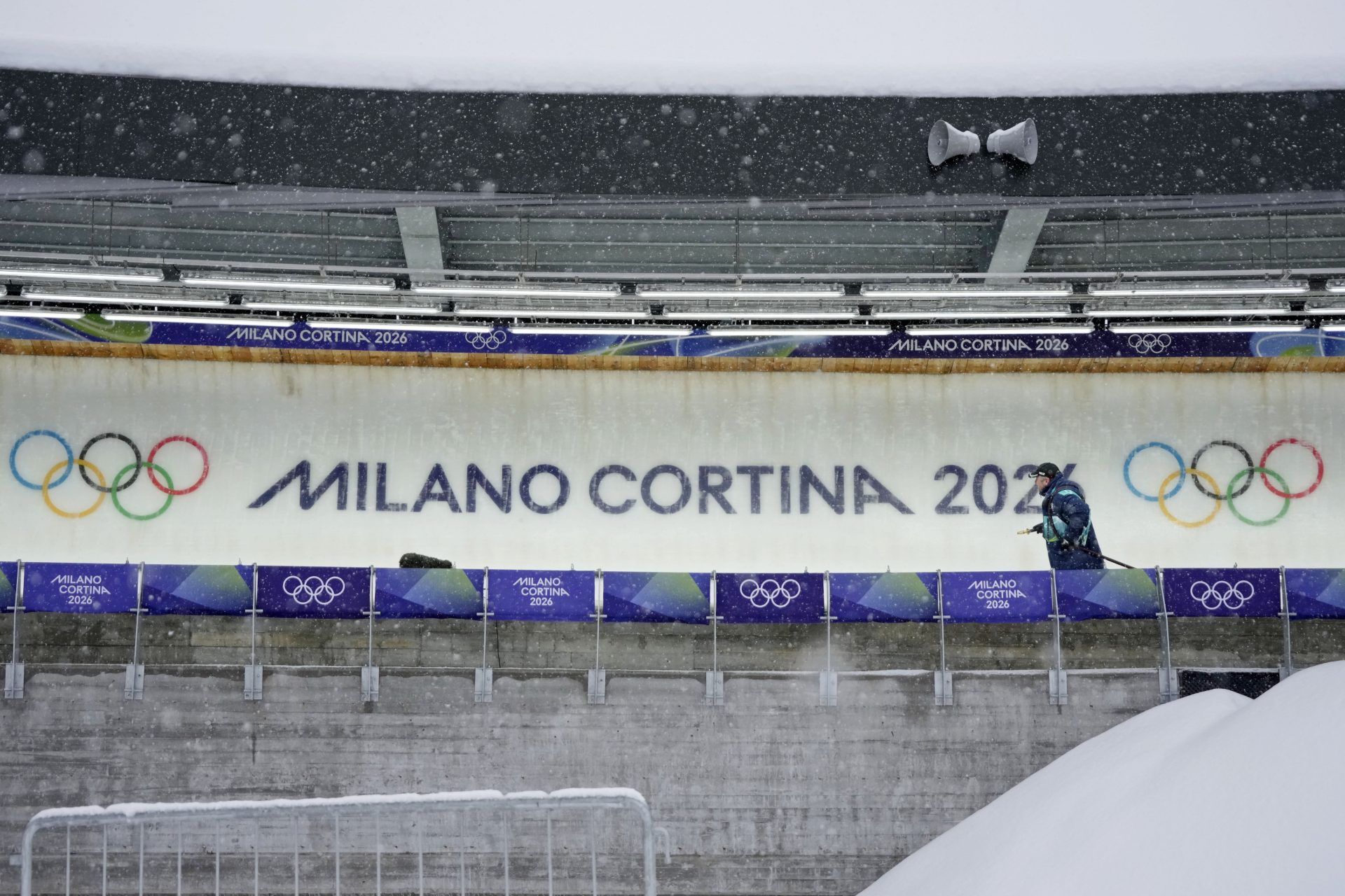 Feb 4, 2026; Cortina d'Ampezzo, ITALY; A worker sprays down the sliding surface ahead of the Milano Cortina 2026 Olympic Winter Games at the Cortina Sliding Centre.