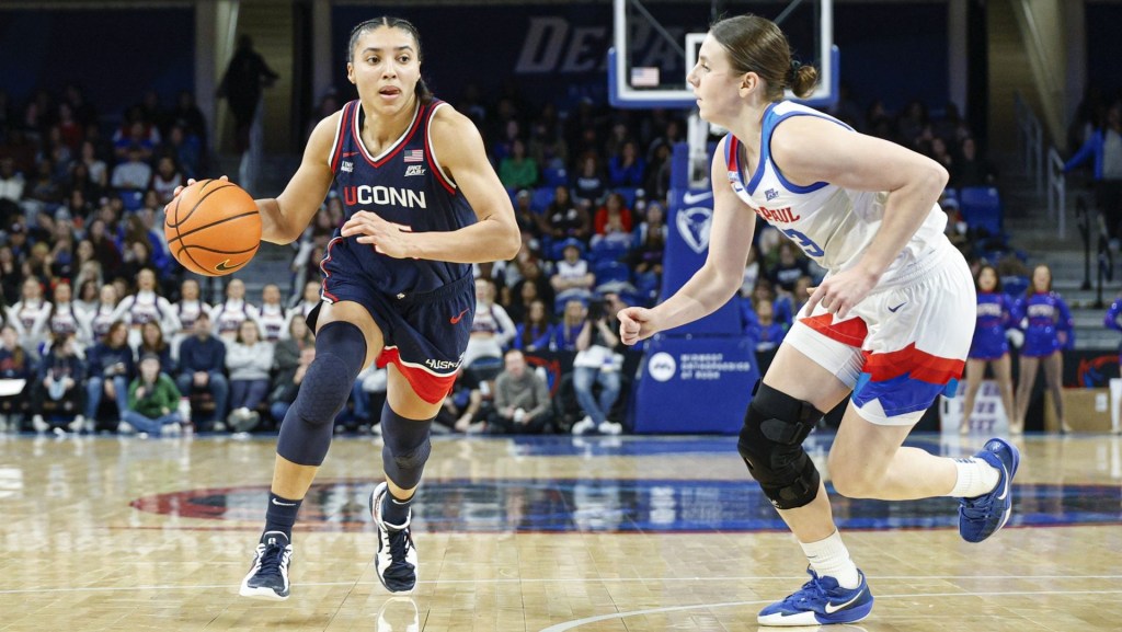 Feb 4, 2026; Chicago, Illinois, USA; UConn Huskies guard Azzi Fudd (35) drives to the basket against DePaul Blue Demons guard Kate Novik (33) during the first half at Wintrust Arena.