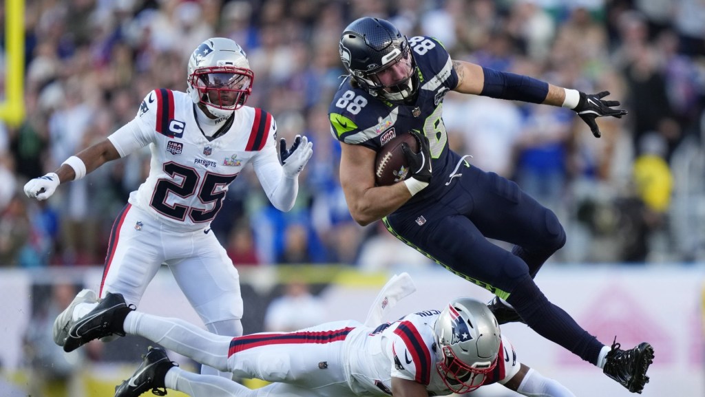Feb 8, 2026; Santa Clara, CA, USA; Seattle Seahawks tight end AJ Barner (88) makes a catch against New England Patriots safety Craig Woodson (31) and cornerback Marcus Jones (25) during the first quarter in Super Bowl LX at Levi's Stadium.
