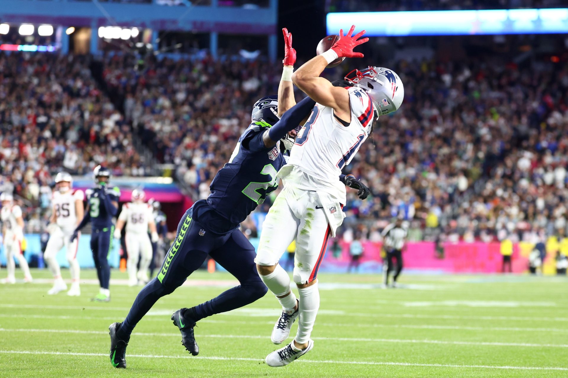 Feb 8, 2026; Santa Clara, CA, USA; New England Patriots wide receiver Mack Hollins (13) makes a catch to score a touchdown against Seattle Seahawks cornerback Riq Woolen (27) during the fourth quarter in Super Bowl LX at Levi's Stadium.