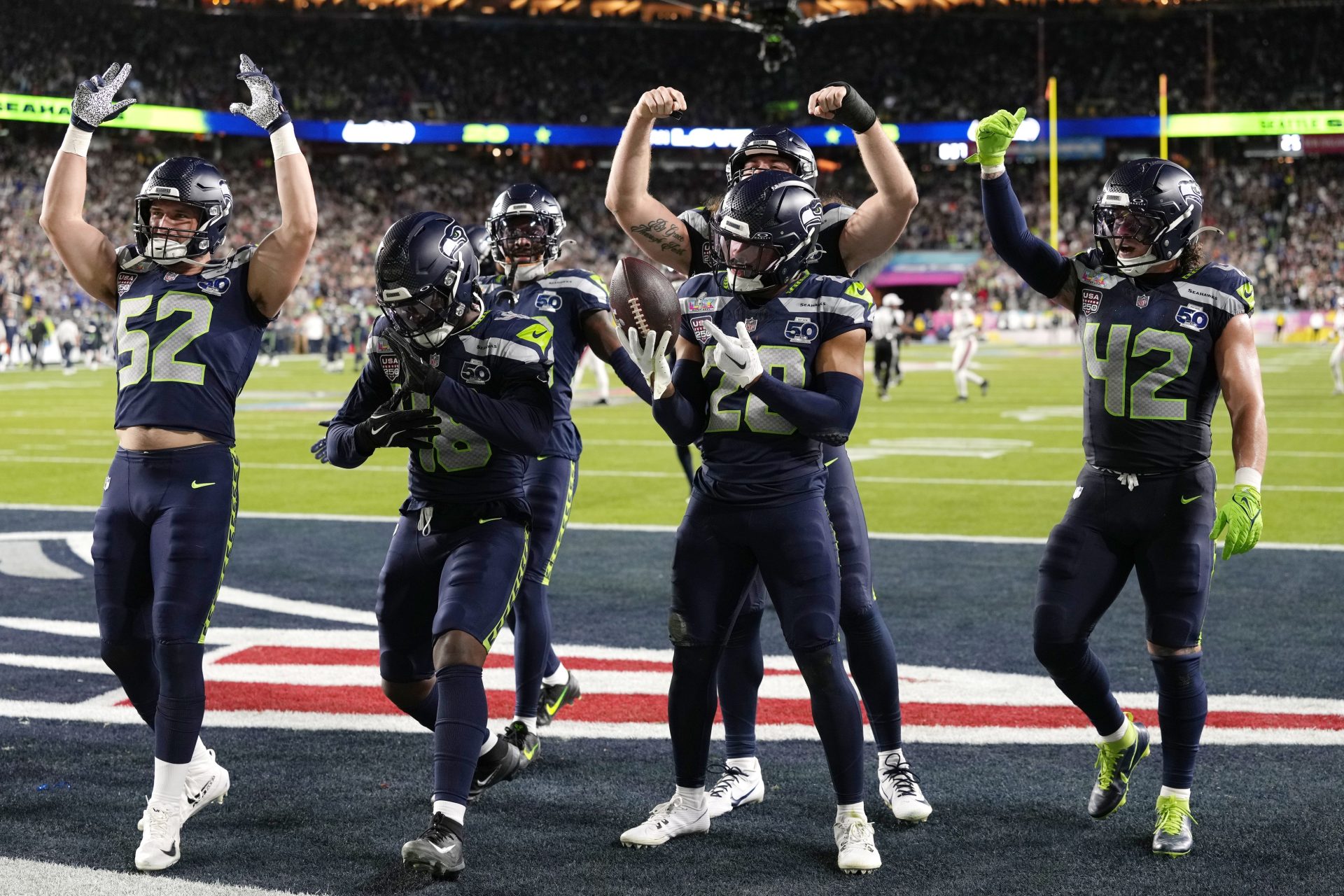 Feb 8, 2026; Santa Clara, CA, USA; Seattle Seahawks safety Julian Love (20) celebrates with teammates after intercepting the ball against the New England Patriots during the fourth quarter in Super Bowl LX at Levi's Stadium.