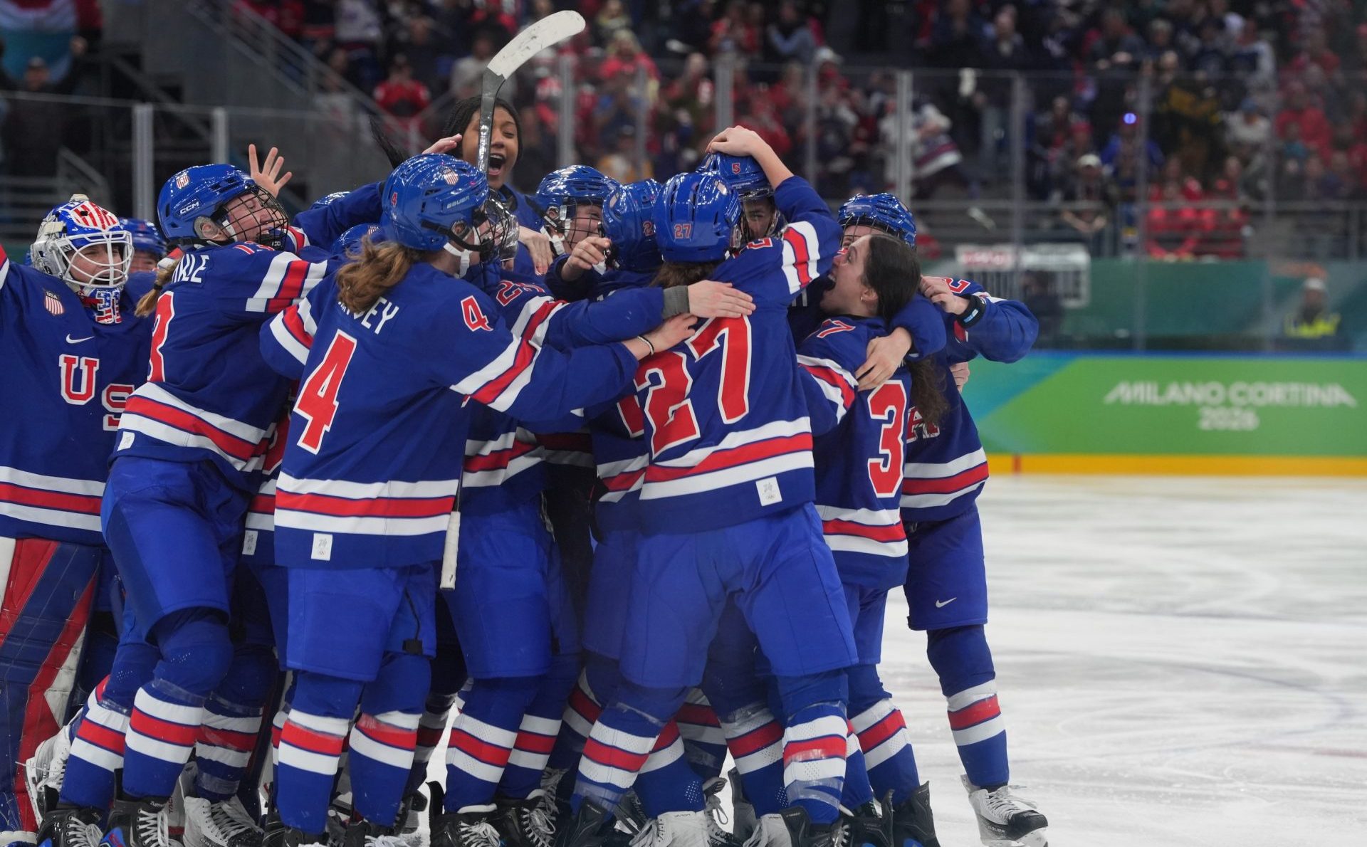 Feb 19, 2026; Milan, Italy; Team USA celebrates winning the Gold Medal in Women’s ice hockey against Canada in overtime of the women's ice hockey gold medal game during the Milano Cortina 2026 Olympic Winter Games at Milano Santagiulia Ice Hockey Arena