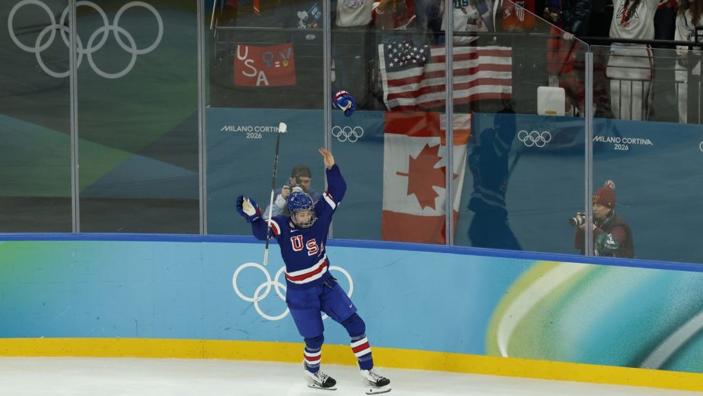 Feb 19, 2026; Milan, Italy; Megan Keller (5) of the United States reacts after scoring the game winning goal against Canada in overtime of the women's ice hockey gold medal game during the Milano Cortina 2026 Olympic Winter Games at Milano Santagiulia Ice Hockey Arena.