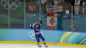 Feb 19, 2026; Milan, Italy; Megan Keller (5) of the United States reacts after scoring the game winning goal against Canada in overtime of the women's ice hockey gold medal game during the Milano Cortina 2026 Olympic Winter Games at Milano Santagiulia Ice Hockey Arena.