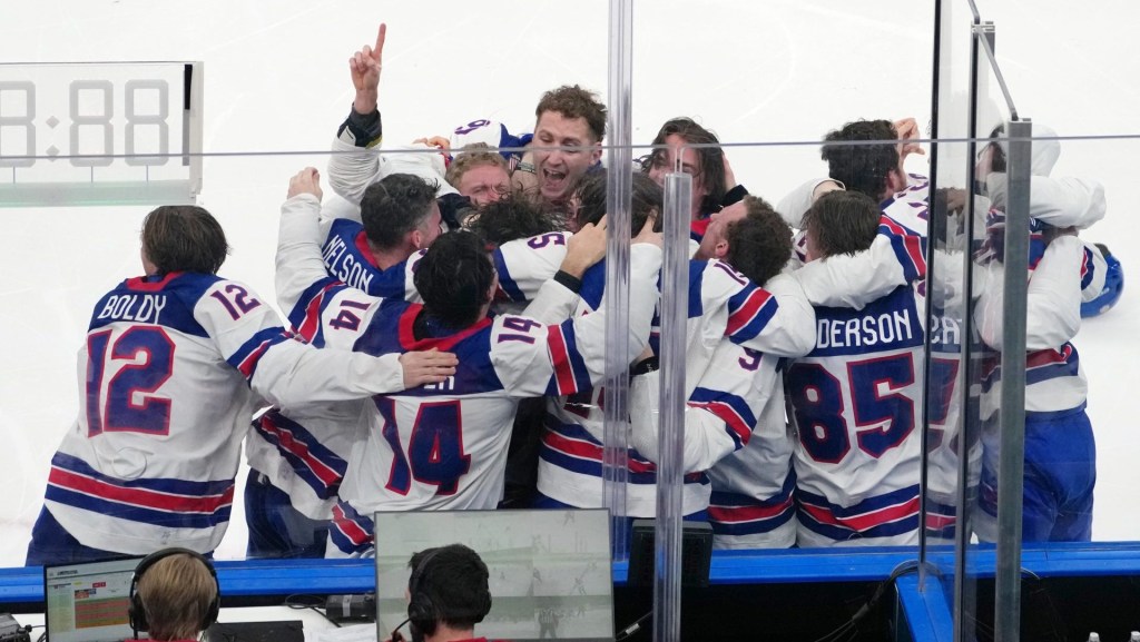 Feb 22, 2026; Milan, Italy; The United States celebrates after winning the men's ice hockey gold medal game during the Milano Cortina 2026 Olympic Winter Games at Milano Santagiulia Ice Hockey Arena
