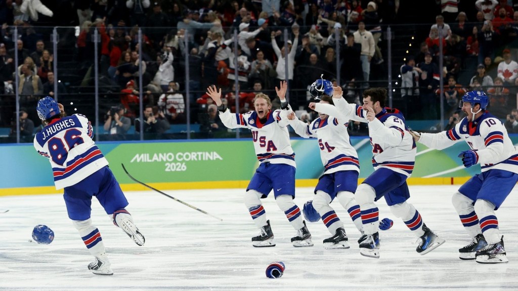 Milan, Italy; Jack Hughes (86) of the United States celebrates with teammates after scoring the game-winning goal against Canada in the men's ice hockey gold medal game during the Milano Cortina 2026 Olympic Winter Games at Milano Santagiulia Ice Hockey Arena.