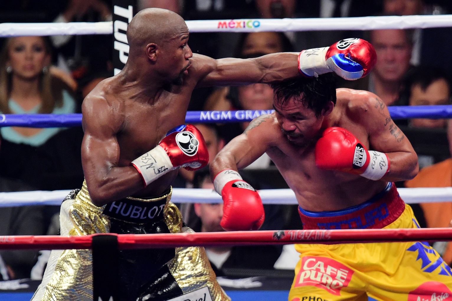 May 2, 2015; Las Vegas, NV, USA; Floyd Mayweather (black/gold trunks) and Manny Pacquiao (yellow/red trunks) box during their world welterweight championship bout at MGM Grand Garden Arena. Mayweather won via unanimous decision.