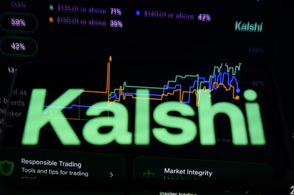 Kalshi's logo is displayed on a smartphone placed on a reflective surface onto which a betting curve is projected in Creteil, France, on March 9, 2026, during a major scandal and a $54 million lawsuit concerning bets related to recent strikes in Iran. (Photo by Samuel Boivin/NurPhoto)NO USE FRANCE