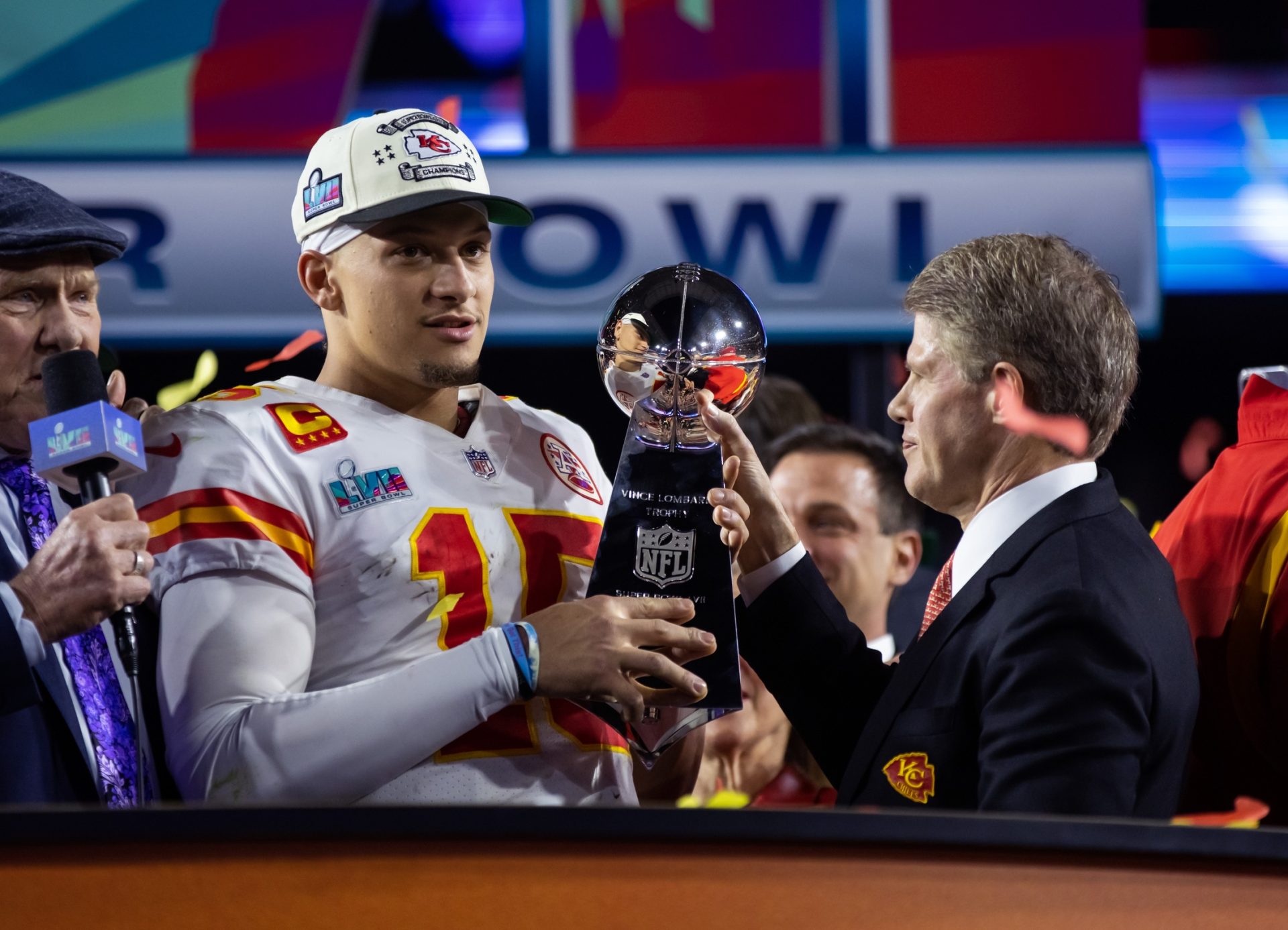 Feb 12, 2023; Glendale, Arizona, US; Kansas City Chiefs quarterback Patrick Mahomes (15) is handed the Vince Lombardi Trophy by team owner Clark Hunt after defeating the Philadelphia Eagles during Super Bowl LVII at State Farm Stadium.