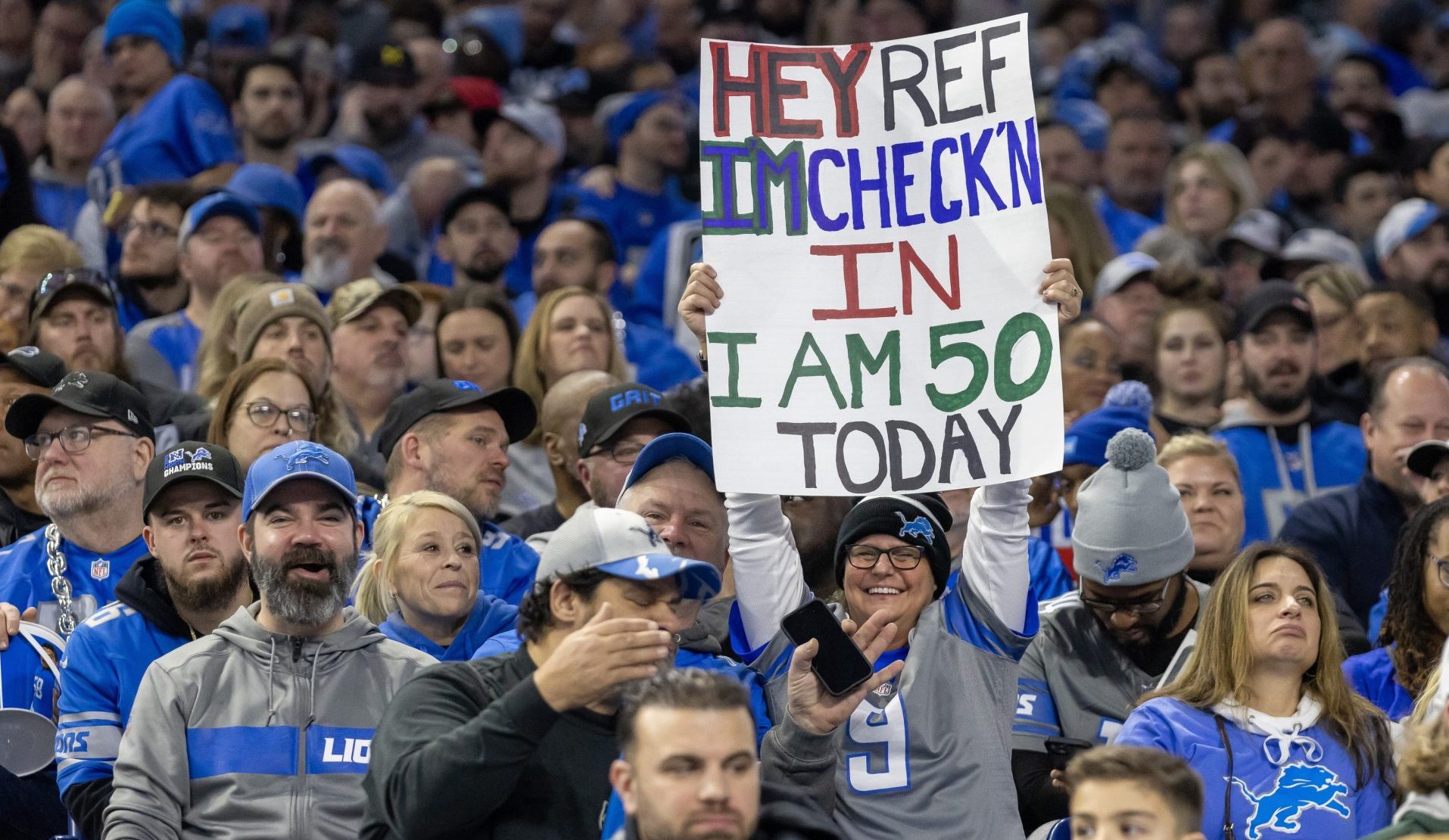 Jan 7, 2024; Detroit, Michigan, USA; A fans holds up a sign mocking the refs during second quarter of the game between the Detroit Lions and the Minnesota Vikings at Ford Field.