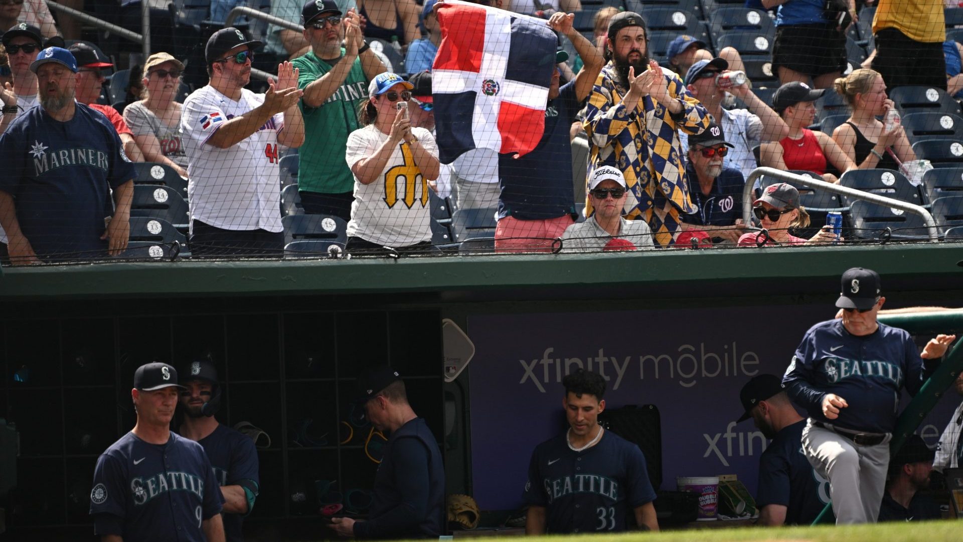 May 26, 2024; Washington, District of Columbia, USA; Seattle Mariners fans hold up a flag of the Dominican Republic after center fielder Julio Rodriguez (44) gets a bae hit (not pictured) during the ninth inning at Nationals Park. Mandatory Credit: Rafael Suanes-USA TODAY Sports