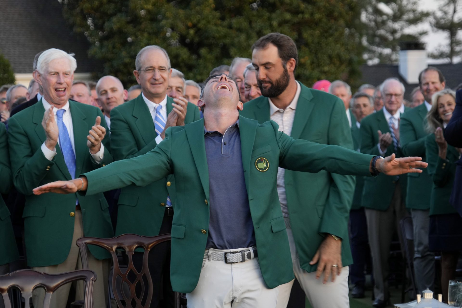 Apr 13, 2025; Augusta, Georgia, USA; Scottie Scheffler presents Rory McIlroy with the green jacket after winning the Masters Tournament at Augusta National Golf Club.