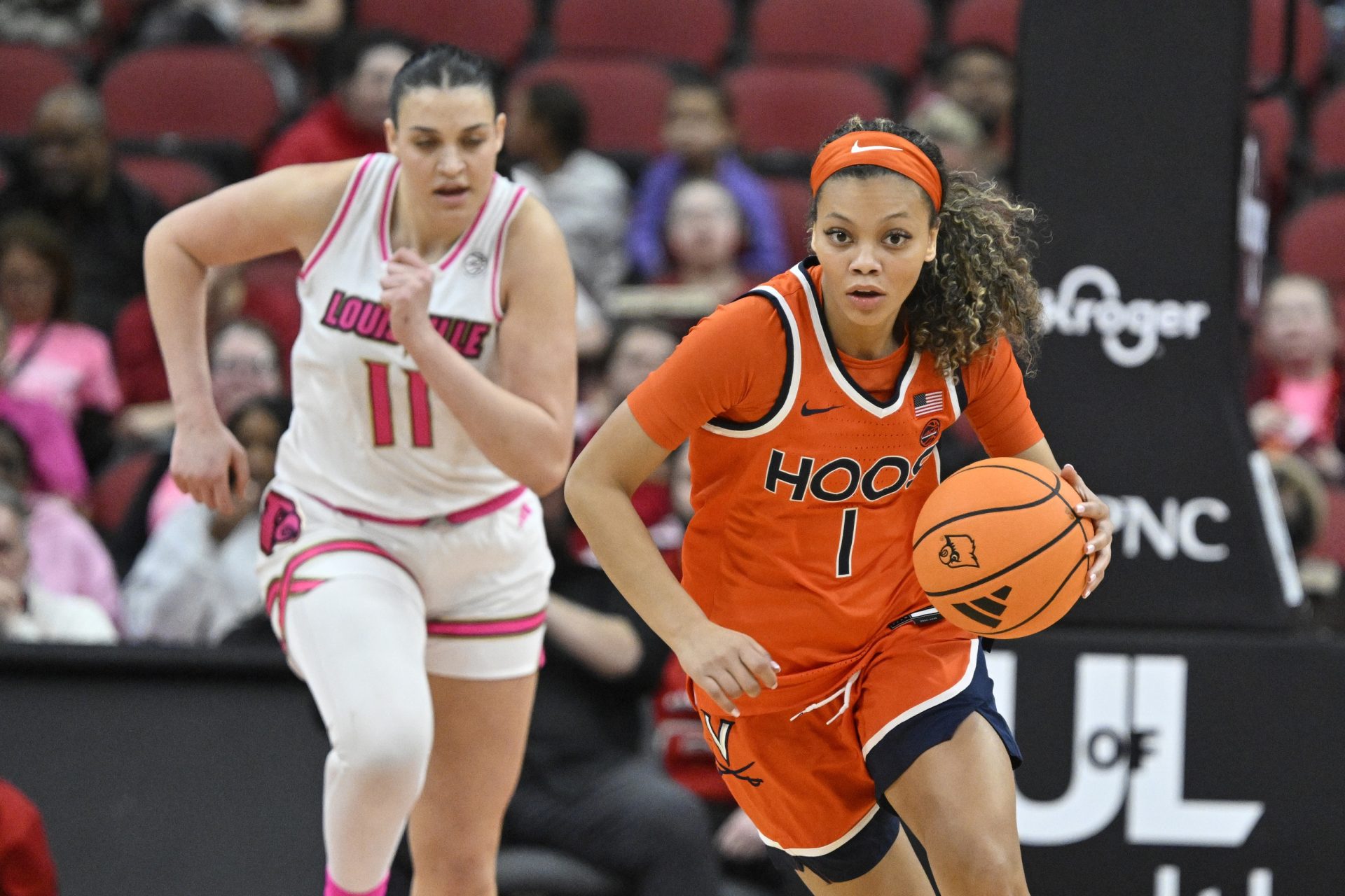 Feb 22, 2026; Louisville, Kentucky, USA; Virginia Cavaliers guard Paris Clark (1) dribbles against Louisville Cardinals forward Elif Istanbulluoglu (11) during the second half at KFC Yum! Center.