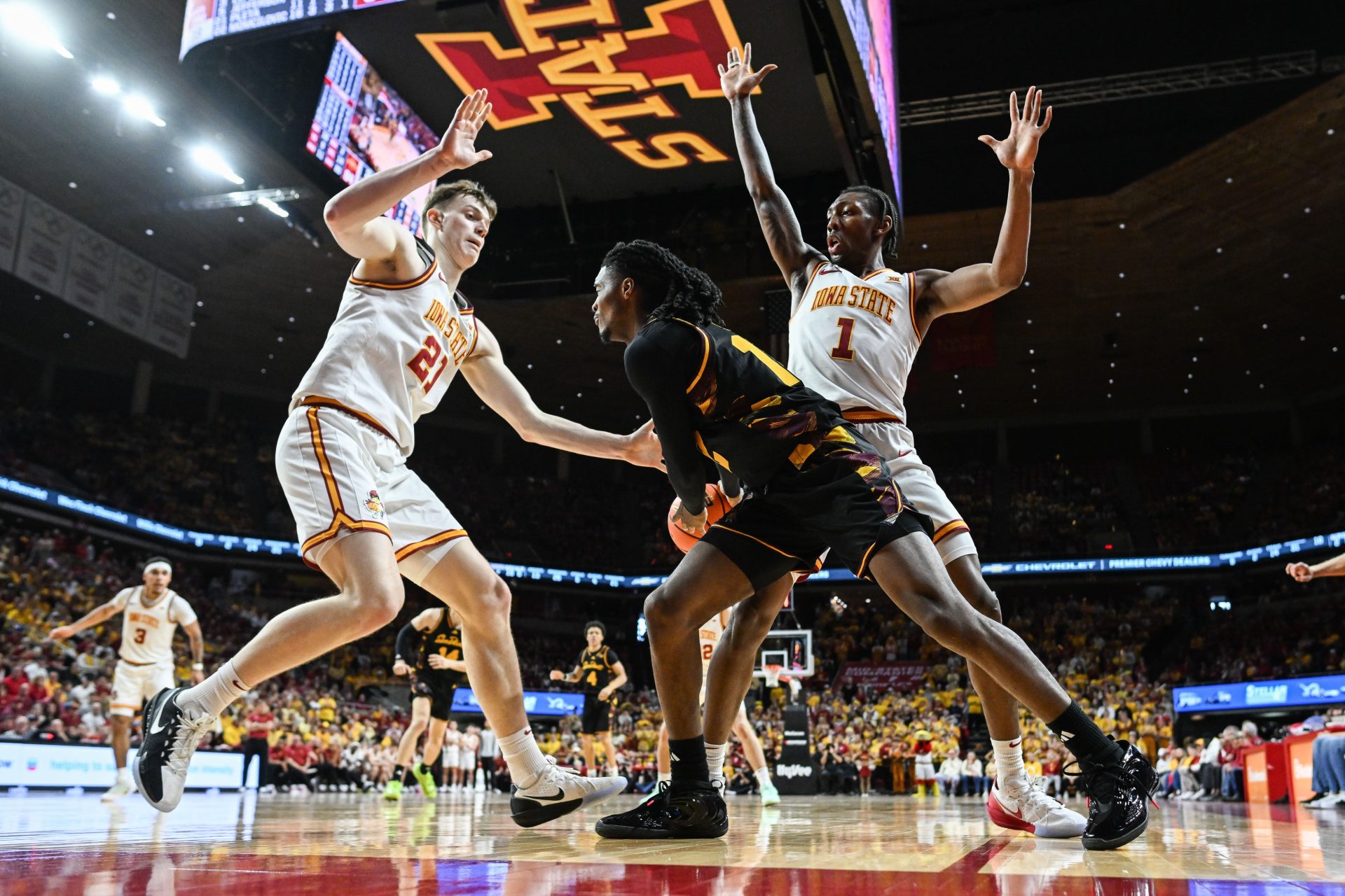 Mar 7, 2026; Ames, Iowa, USA; Arizona State Sun Devils guard Trevor Best (12) is defended by Iowa State Cyclones guard Jamarion Batemon (1) and forward Dominykas Pleta (21) during the second half at James H. Hilton Coliseum.