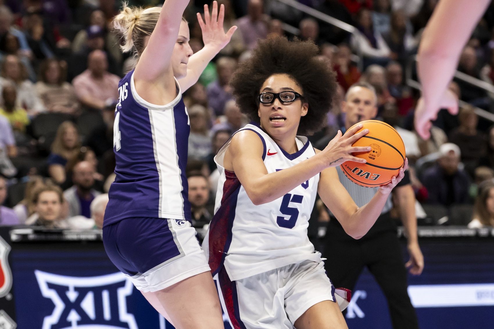 Mar 7, 2026; Kansas City, MO, USA; TCU Horned Frogs guard Olivia Miles (5) attempts to drive the ball past Kansas State Wildcats forward Nastja Claessens (4) during the second half at T-Mobile Center.
