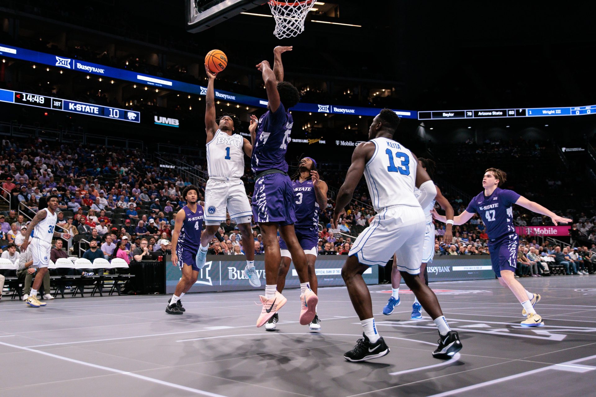 Mar 10, 2026; Kansas City, MO, USA; BYU Cougars guard Robert Wright III (1) shoots the ball over Kansas State Wildcats forward Taj Manning (15) during the first half at T-Mobile Center.