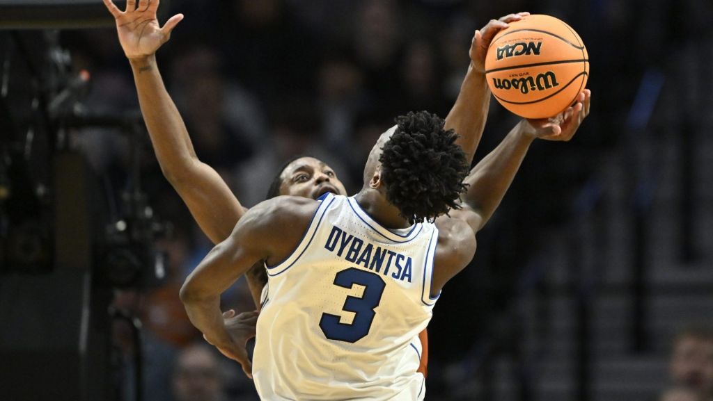Mar 19, 2026; Portland, OR, USA; Texas Longhorns guard Tramon Mark (12) blocks BYU Cougars forward AJ Dybantsa (3) in the second half during a first round game of the men's 2026 NCAA Tournament at Moda Center. Mandatory Credit: Craig Strobeck-Imagn Images