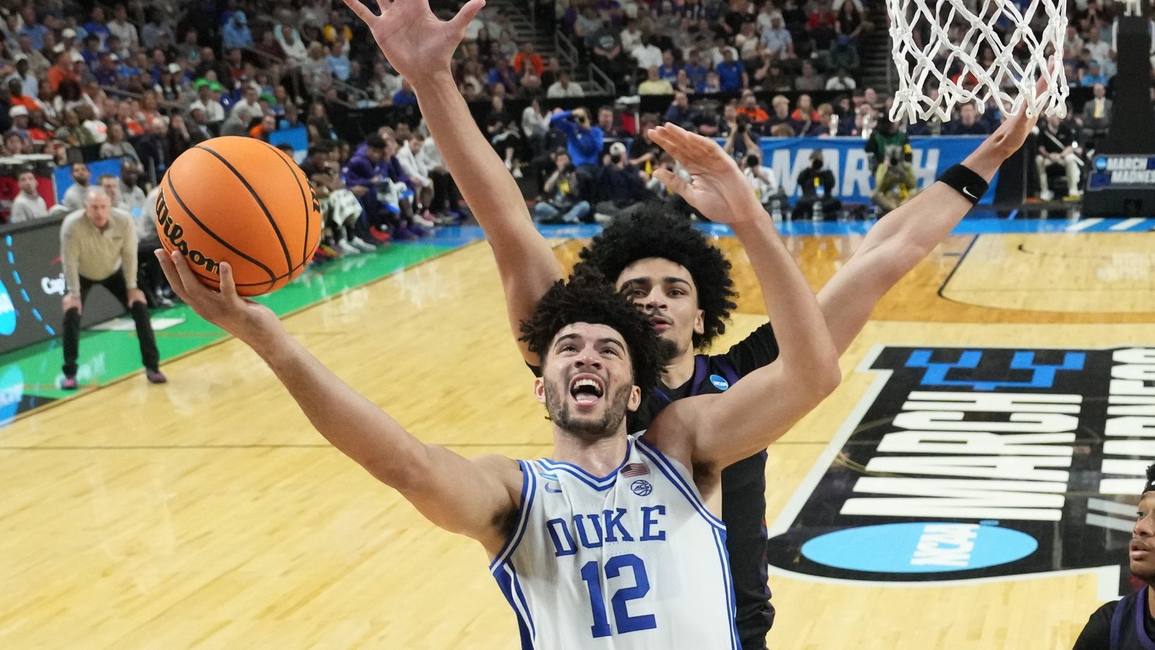 Mar 21, 2026; Greenville, SC, USA; Duke Blue Devils forward Cameron Boozer (12) shoots as Texas Christian University Horned Frogs forward David Punch (15) defends in the second half during a second round game of the men's 2026 NCAA Tournament at Bon Secours Wellness Arena. Mandatory Credit: Bob Donnan-Imagn Images