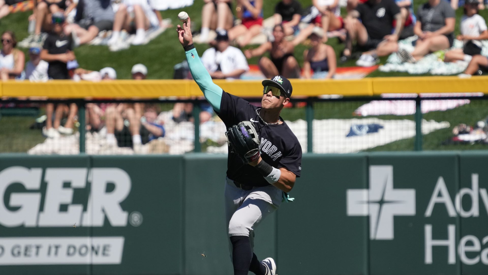 Mar 23, 2026; Mesa, Arizona, USA; New York Yankees right fielder Aaron Judge (99) fields the ball against the Chicago Cubs in the third inning at Sloan Park.